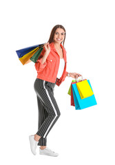 Young woman with shopping bags on white background