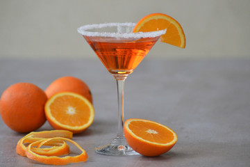 Classic Italian Aperol Spritz cocktail in martini glass on gray background. Copy space.