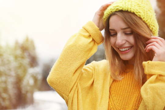 Young woman in warm clothes outdoors. Winter vacation