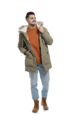Fototapeta premium Young man wearing warm clothes on white background. Ready for winter vacation
