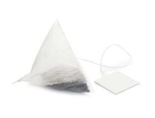 Unused pyramid tea bag with tag on white background