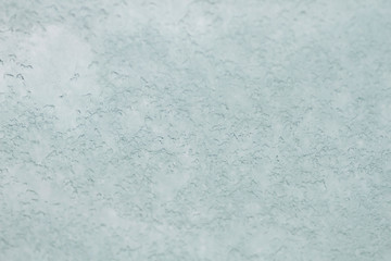 Snow on a window glass, background or texture