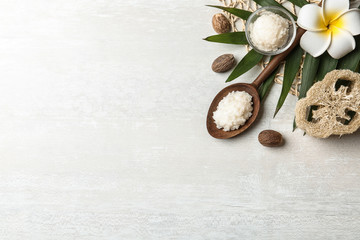 Flat lay composition with Shea butter and nuts on light background. Space for text