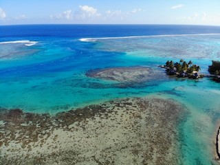 Plakat Aerial view of shades of blue and coral reefs over the Moorea lagoon in French Polynesia, South Pacific