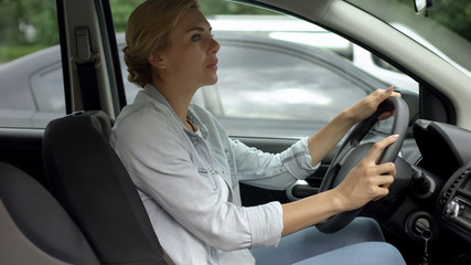 Female attentively looking at road, practicing driving on pre-licensing course