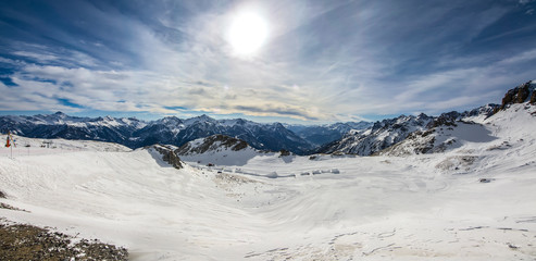 Briancon ski resort slopes, mountain panorama and sun aerial view, France, French Alps