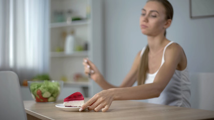 Girl on diet prefers cake instead of salad, temptation, unhealthy lifestyle