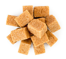 Heap of refined cane sugar on a white. The form of the top.