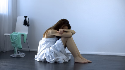 Raped lady sitting on floor, sexual assault victim, women rights, slavery