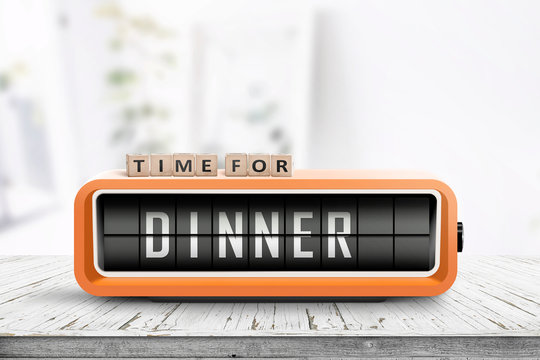 Time for dinner message on a wooden table