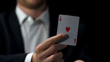 Male player holding ace card, business bluff strategy, chance to win, gambling