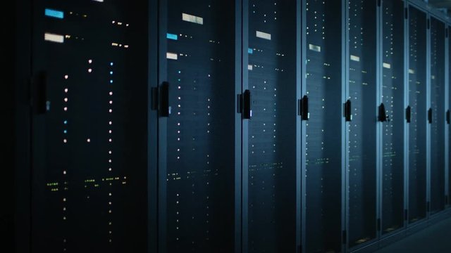 Moving Data Shot of Dark Data Center With Multiple Rows of Fully Operational Server Racks. Modern Telecommunications, Cloud Computing, Artificial Intelligence, Database, Supercomputer