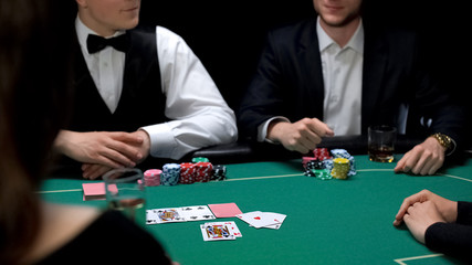 Rich man drinking scotch playing poker at casino, gambling business, upper class