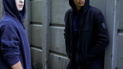 Hooded teenagers waiting for victim, extortion of money, young criminals