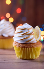 Lemon muffins with protein cream and beautiful lights in a dark key