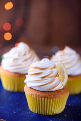 Lemon muffins with protein cream and beautiful lights in a dark key