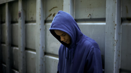 Upset afro-american guy feeling lonely, lack of friends, misunderstanding