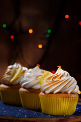 Lemon muffins with protein cream and beautiful lights in a dark key