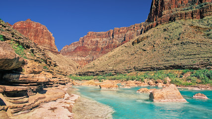 Aquamarine waters of the Little Colorado River flow towards its confluence with the Colorado River...