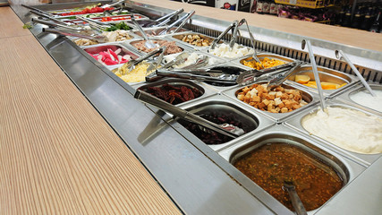 Concept of selling unhealthy food by weight in a store. Vegetables, fruits, meat, salad.