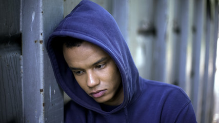 Mixed-race guy suffering from bullying, racial discrimination, cruel youth