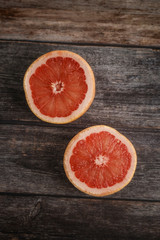 Fototapeta na wymiar Grapefruit citrus fruit with half on wooden background