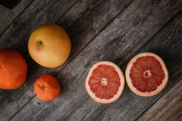 Fresh citrus fruits on color wooden background. Grapefruit, orange and mandarin