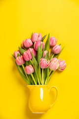 Fresh pink tulips in a jug, close up