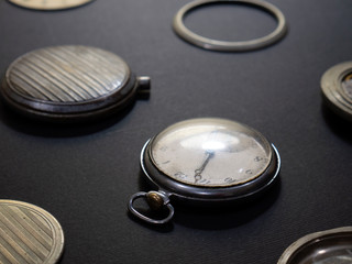 Mechanisms of watches and their parts on a black background