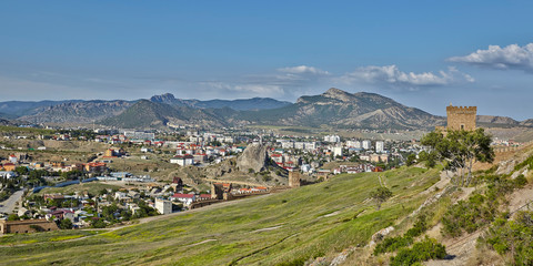 Fototapeta na wymiar Beautiful view to Sudak fromGenoese fortress built on rocks above sea in Sudak city of Crimea.