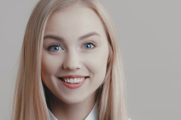 Naklejka premium Young playful cute blonde with bow tie is smiling