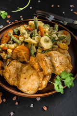 Fried chicken fillet with vegetables.