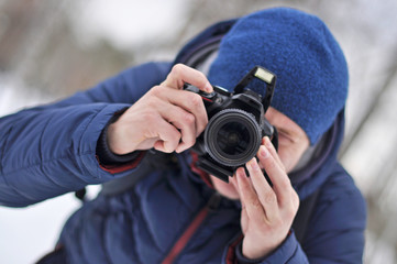 A man takes pictures in a hat and jacket. Portrait.