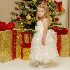 The girl at the Christmas tree.