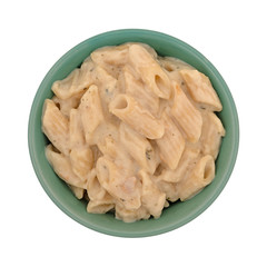 Bowl of pasta with chicken in an alfredo sauce on a white background