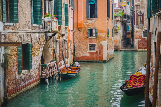 Boats moored in canal near residential buildings