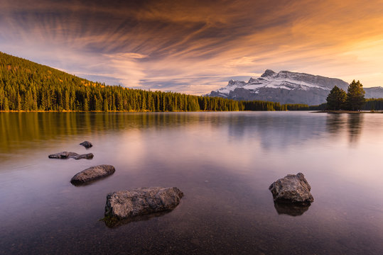 Scenic view of Two Jake Lake against cloudy sky during sunrise