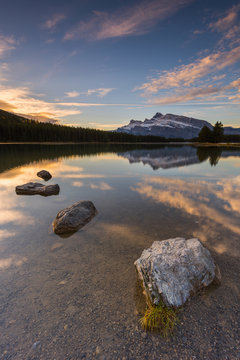 Scenic view of Two Jake Lake against cloudy sky during sunrise