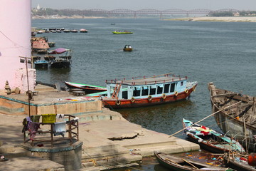 Ganga river scenery with moored boats at Lalita Ghat in Varanasi, India