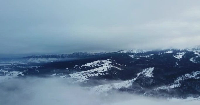 Epic Aerial Flight Near Mountain Clouds Towards Sunrise. Picturesque and gorgeous scene.