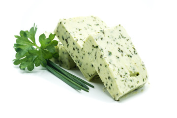 Piece of herb butter isolated on white background