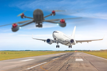Fototapeta na wymiar Quadcopter Drone Unmanned Aircraft System UAV in the air too close to passenger airplane. Plane in selective focus. Concept flight danger disruption