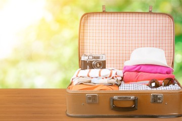 Suitcase with clothes and other travel accessories