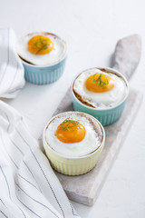 Shirred baked eggs for breakfast. Selective focus copy space