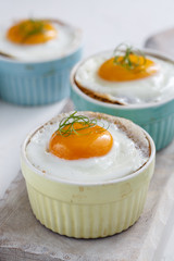 Shirred eggs for breakfast. Selective focus copy space