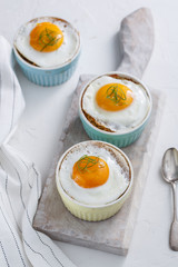 Ramekins baked eggs on white background, top view