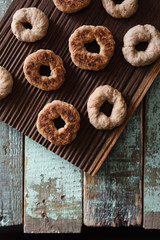 Homemade hygge sweets. Small wholegrain vegetarian cookies on oak board on shabby blue background top view