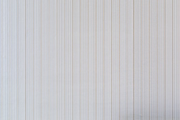 High resolution full frame background of pale and beige colored striped wallpaper.