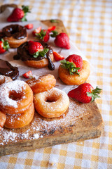 Homemade donuts with powdered sugar and strawberry 