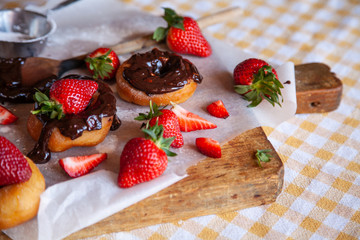 Homemade donuts with powdered sugar and strawberry 